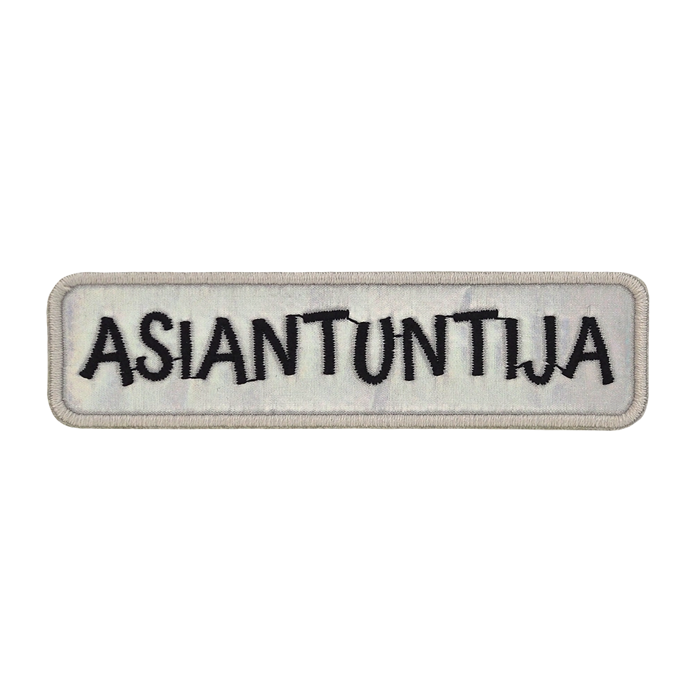 Brodeerattu haalarimerkki, hologrammikankaalla. Teksti: Asiantuntija.