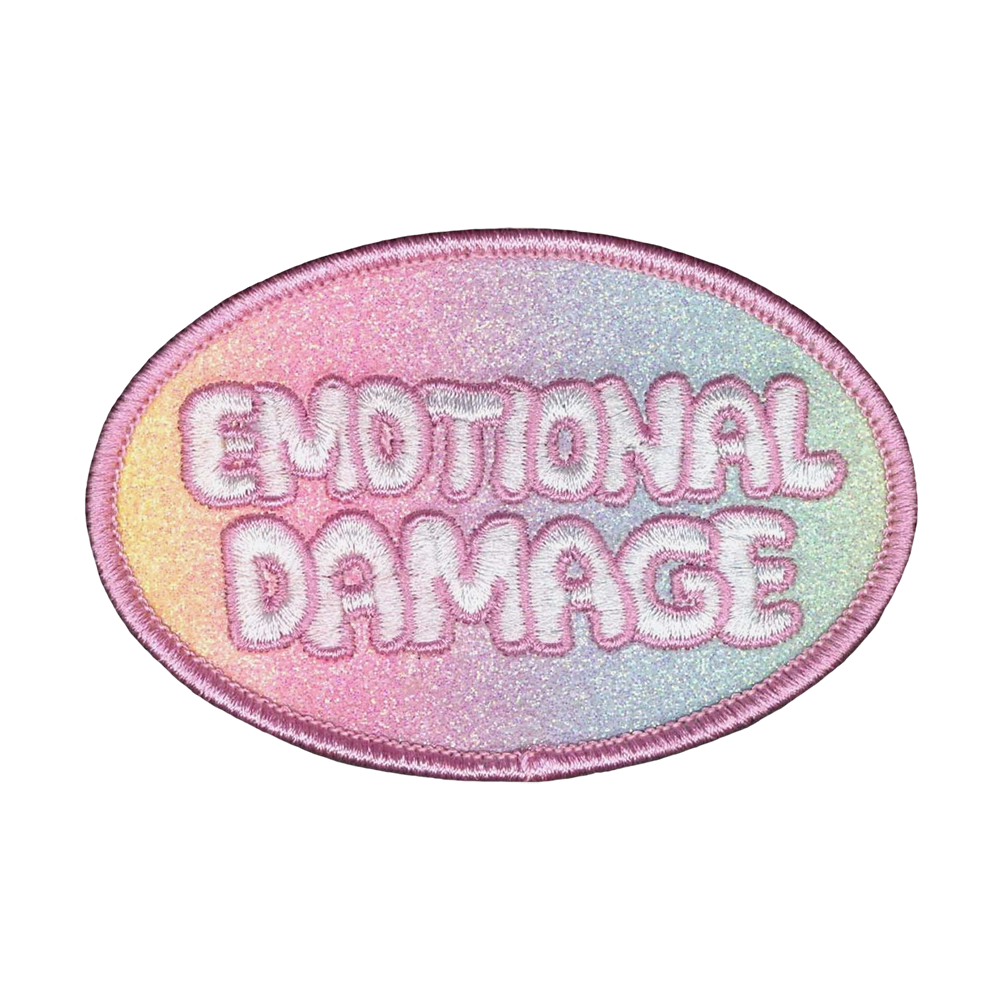 Brodeerattu kangasmerkki, glitterpohja, teksti: Emotional damage.