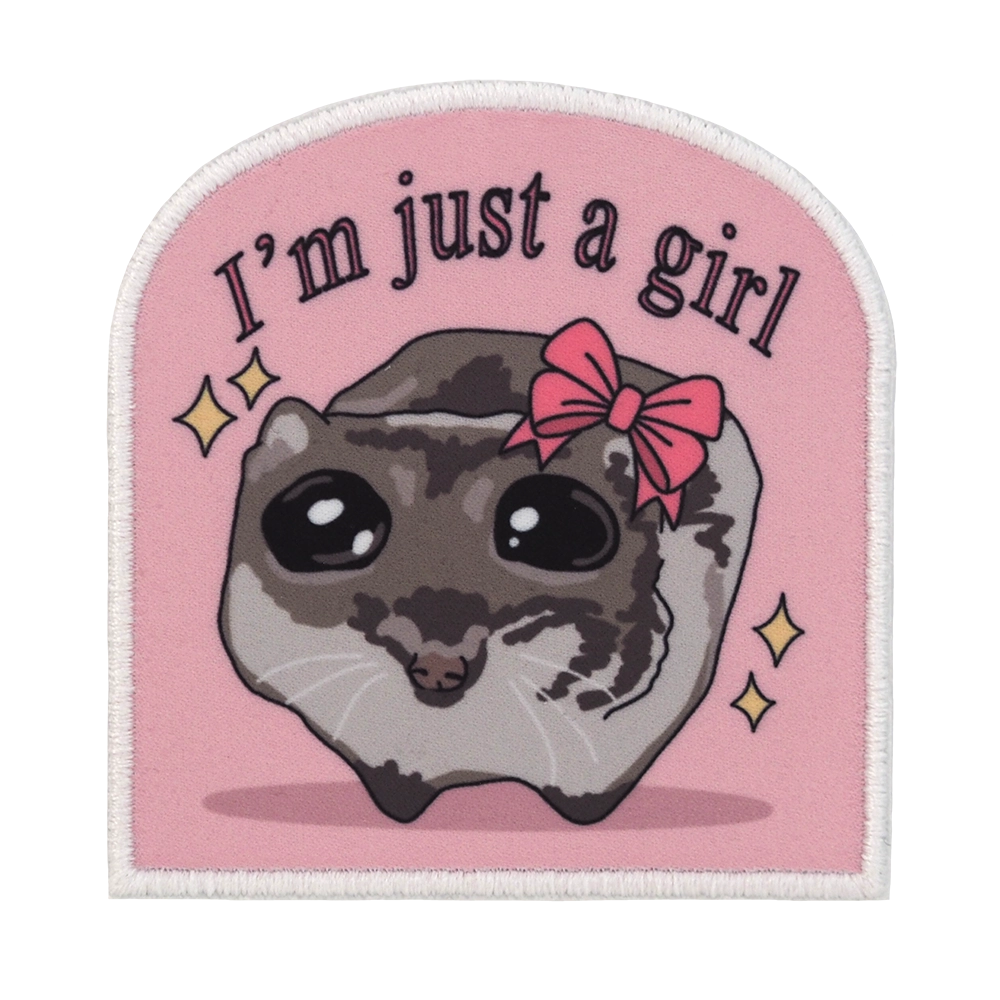 Painettu kangasmerkki, hamsteri, teksti: I'm just a girl.