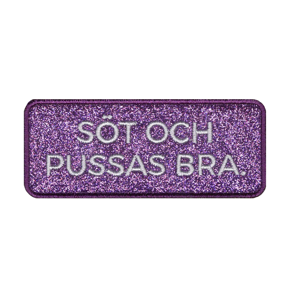 Glitterkankainen kangasmerkki.