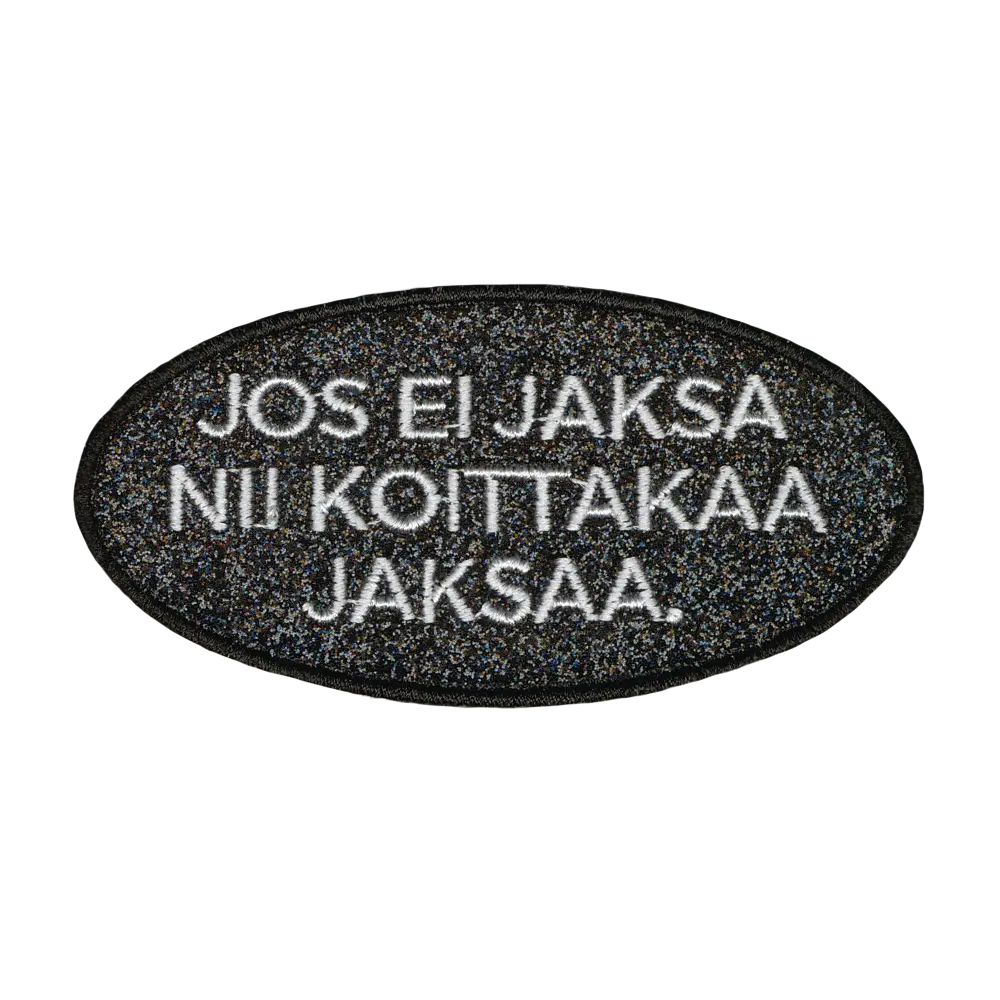 Brodeerattu glitterkangasmerkki.